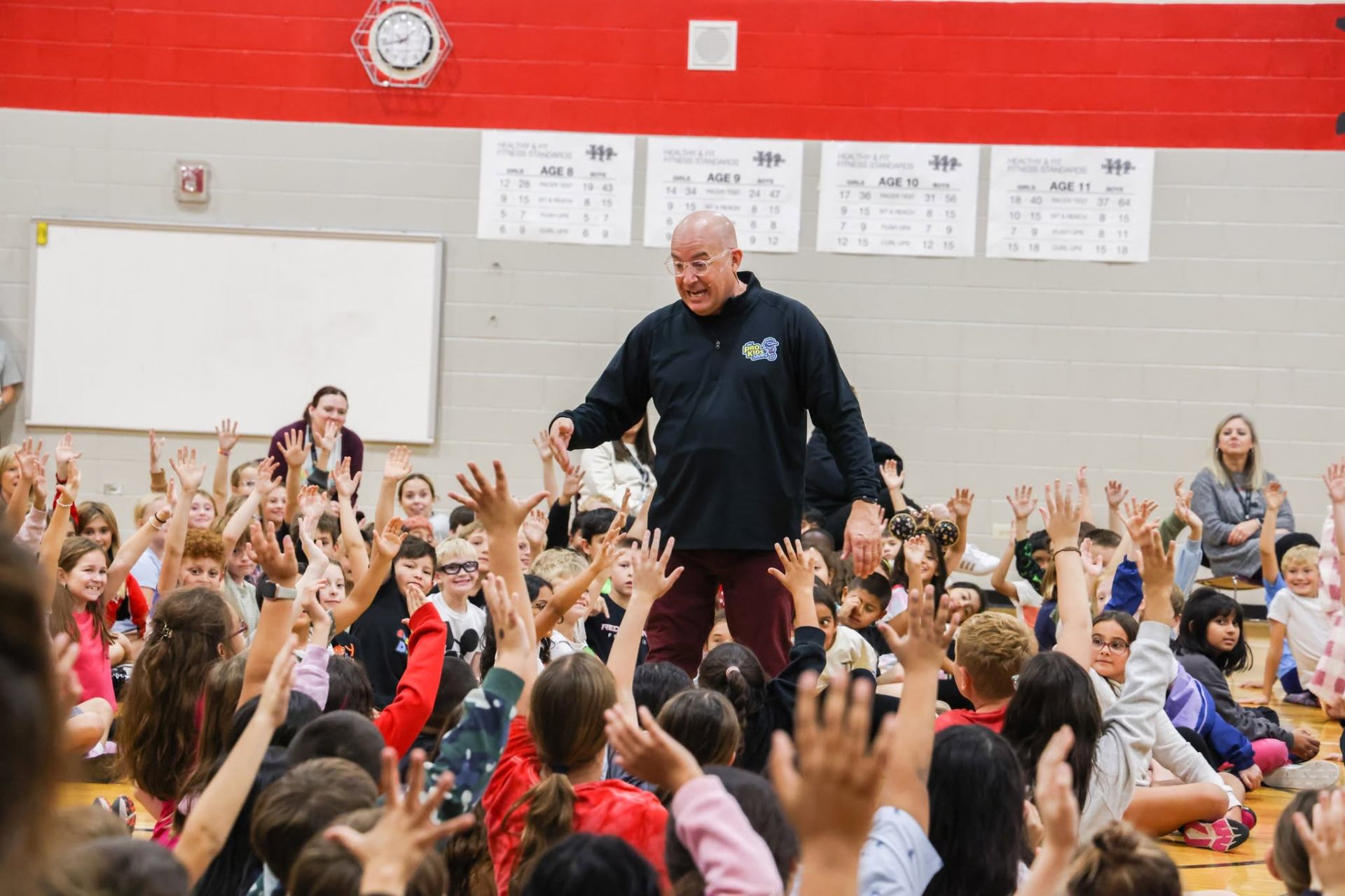 Tim in the crowd at an elementary assembly
