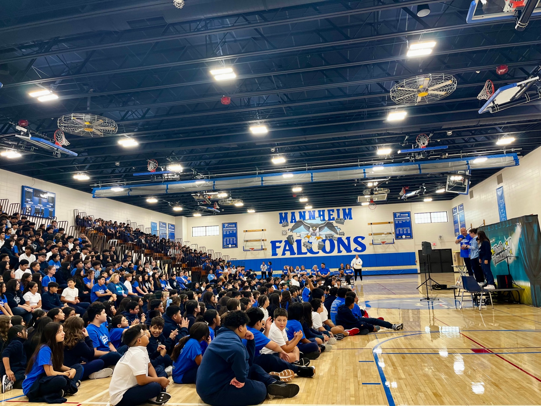 Middle school gymnasium packed with students during an assembly